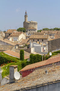 High angle view of old buildings in town against sky