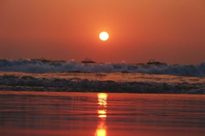 Scenic view of sea against romantic sky at sunset