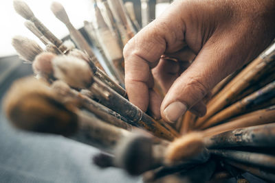 Close-up of woman holding brushes