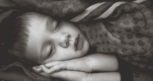 Portrait of cute baby sleeping on bed