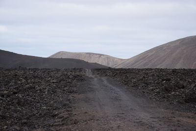 View of volcanic land against sky