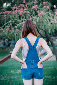 Rear view of woman standing on field