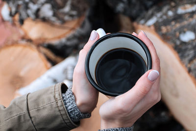 Close-up of hands holding coffee cup