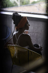 Young latin woman in balcony