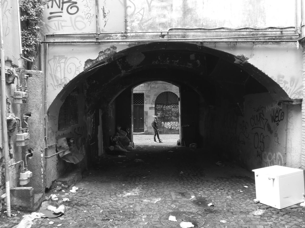 MAN STANDING AMIDST OLD BUILDING