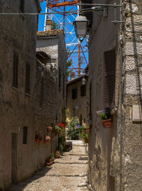 Narrow alley amidst buildings in city