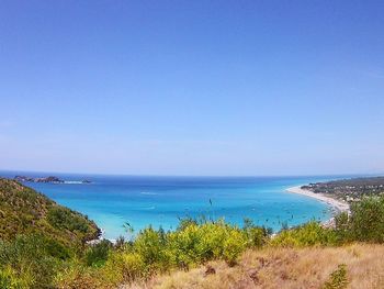 Scenic view of sea against clear blue sky