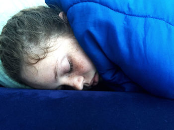 Close-up of man sleeping on bed