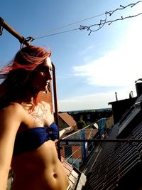 Portrait of woman by sea against sky