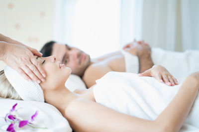 Midsection of woman lying on bed