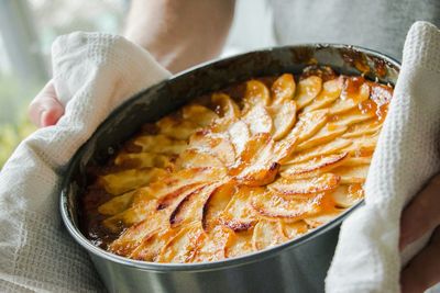 Cropped image of man holding homemade apple cake