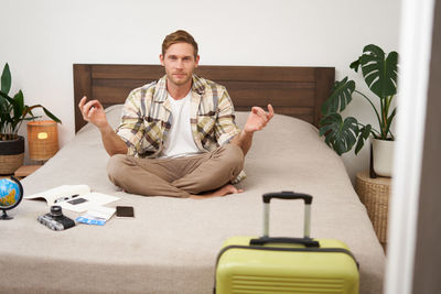 Portrait of senior man sitting on sofa at home