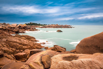 Rocks on beach against sky