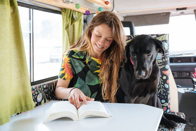 Woman traveling with dog in camper van