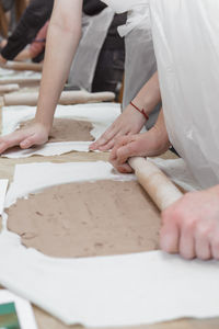 Midsection of people working on table