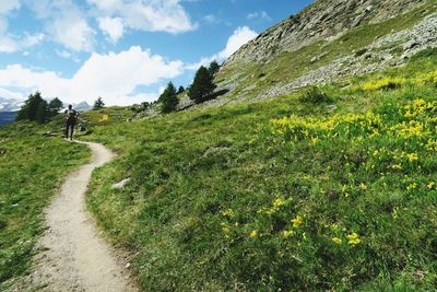 Scenic view of road amidst mountains against sky