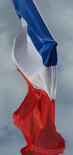 Low angle view of flag against sky