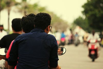 Rear view of friends on motorcycle