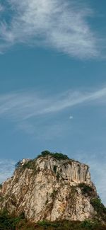 Low angle view of rock formation against sky