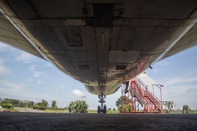 Bridge over road in city against sky