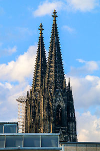 Low angle view of building against cloudy sky