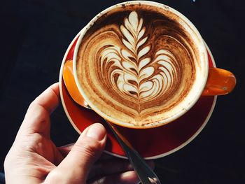 Close-up of hand holding coffee cup