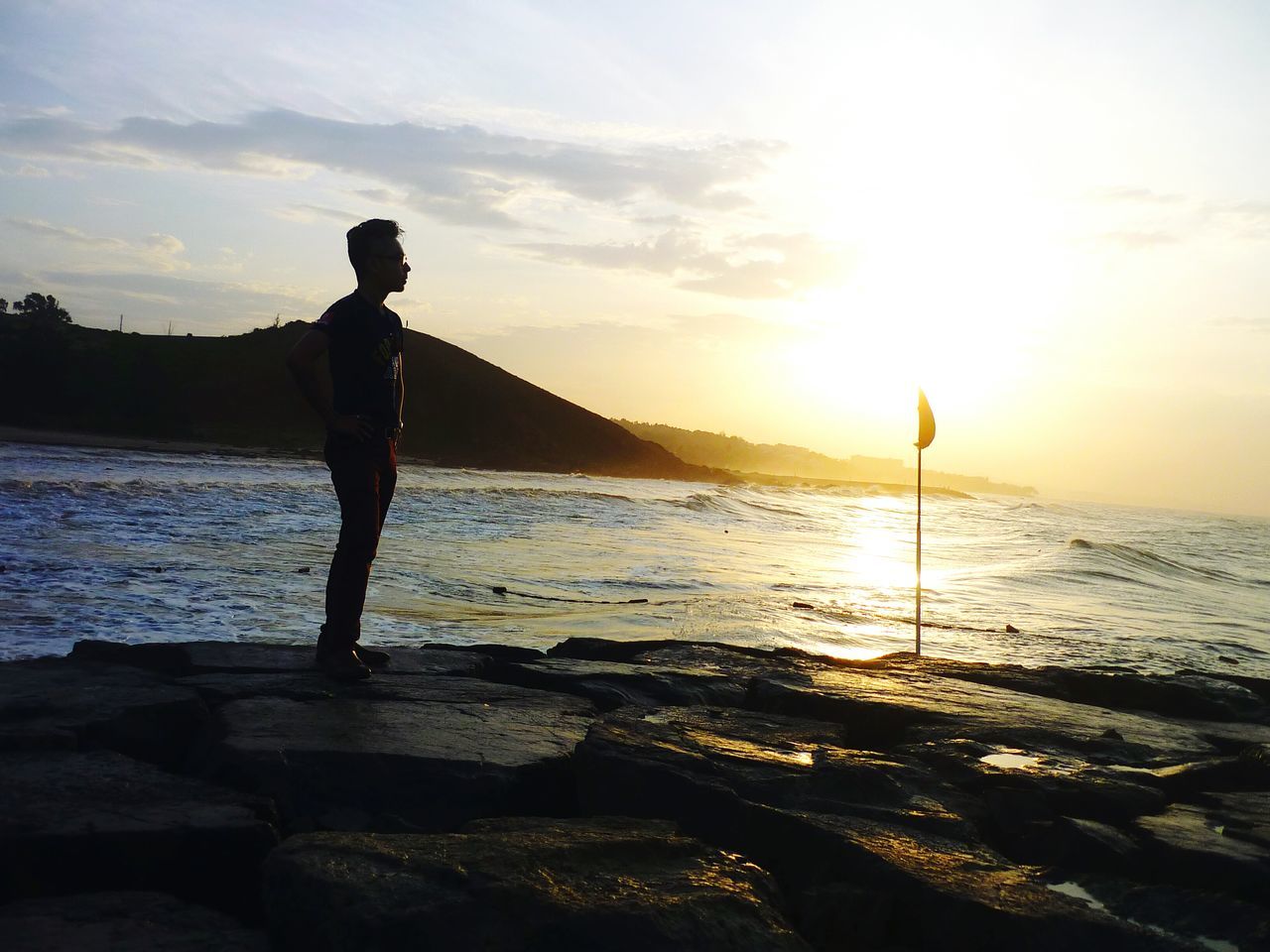 water, sunset, silhouette, sea, sky, sun, beach, leisure activity, scenics, lifestyles, beauty in nature, horizon over water, tranquil scene, tranquility, shore, standing, full length, nature