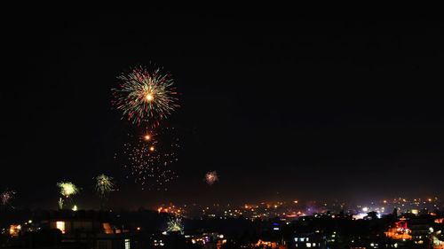 Low angle view of illuminated fireworks against sky at night