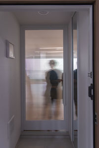 Blurred motion of woman walking in building