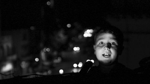 Portrait of girl with illuminated lighting equipment at night