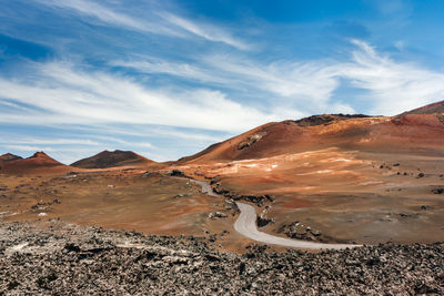 Scenic view of arid landscape against sky