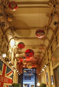 Low angle view of illuminated chandelier hanging from ceiling