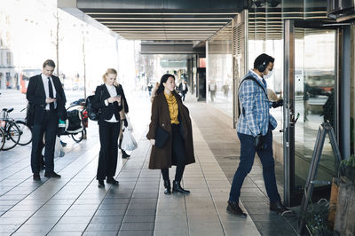 People walking in corridor of building