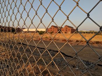 Full frame shot of chainlink fence against sky