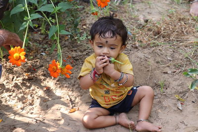 Portrait of cute girl sitting outdoors