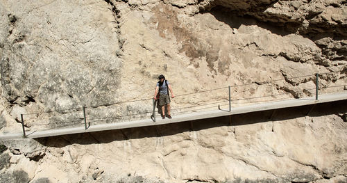 Low angle view of woman walking on mountain