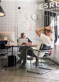 Young business people sitting in creative office