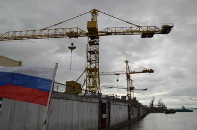 Low angle view of crane against sky