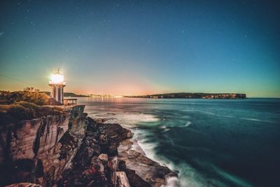 Lighthouse on shore at night