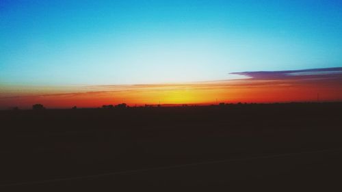 Scenic view of landscape against sky at sunset