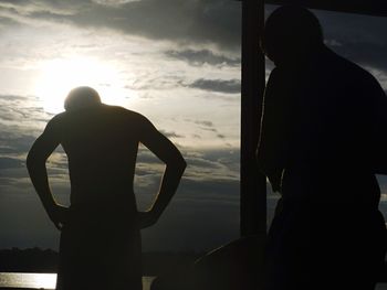 Silhouette of people at sunset