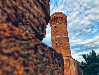 Low angle view of old tower against sky