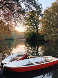 Boats moored in lake during autumn