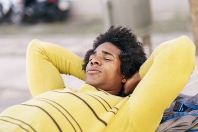 Portrait of smiling man lying on yellow outdoors