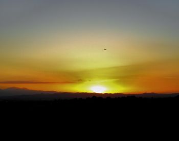Scenic view of silhouette mountain against sky during sunset