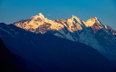 Scenic view of snowcapped mountains against clear sky