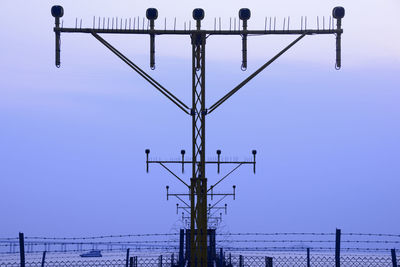 Landing signals light against blue sky