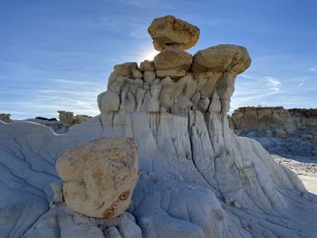 Rock formations on landscape against sky