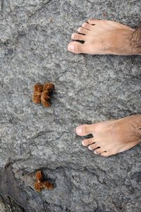 Low section of woman standing on rock