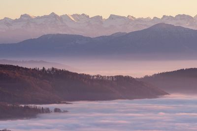 Scenic view of snowcapped mountains against sky during sunset